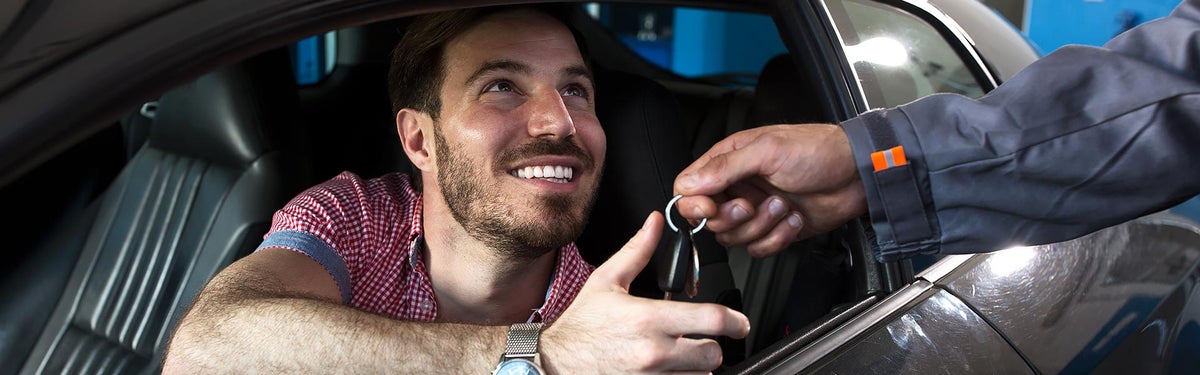 Satisfied Male Customer receiving car keys | All Star Automotive Group in Baton Rouge LA